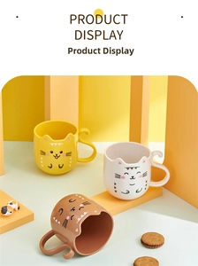 Detail of cat-themed children cups with cute tail handles in yellow, white and brown