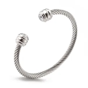 Silver twisted cable wire bangle with round zircon stones in an open adjustable design