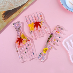 DIY silicone molds for resin afro hair combs featuring dried flowers and glitter details