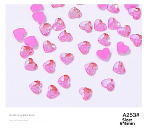 Macro detail of 6x6mm Aurora Pink heart rhinestones for nail art and DIY decor