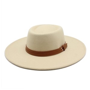 Close-up of beige wool fedora with a brown leather band and metal rivet buckle detail
