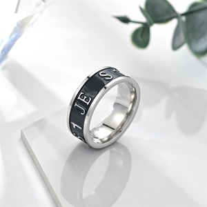 Macro detail of vintage silver stainless steel ring with black enamel and JES lettering