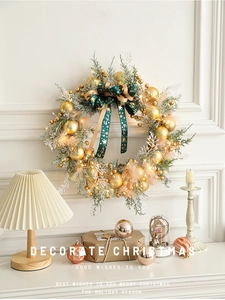Detail of 40cm Christmas wreath with LED lights, golden baubles, and pine branches