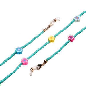 Detail of beaded glasses chain with polymer clay flowers and golden lobster clasps