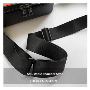 Detail of adjustable black nylon woven shoulder strap with silver metal buckle on bag