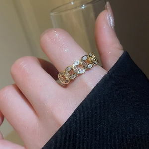 Detailed view of 18k gold plated ring with marquise-cut zircons worn on finger