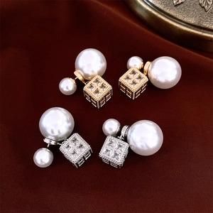 Macro detail of French style square pendant earrings with pearls and brilliant zircons