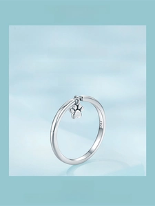 Detail of S925 sterling silver ring showing the cute dog paw charm and engraved logo