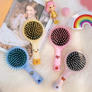 Set di quattro mini spazzole per capelli con disegni di anatra e cuore su pelliccia