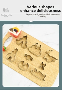Set of 8 stainless steel Christmas cookie cutters on a rustic wooden board