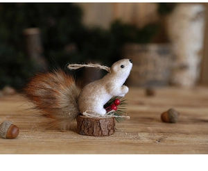 Macro view of Christmas squirrel figurine with fluffy tail, berries, and wooden base