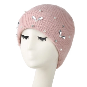 Pink knitted beanie for women featuring white pearls and rhinestone bow embellishments