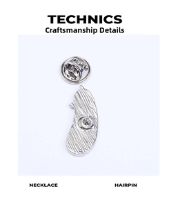 Detail view of the silver eggplant brooch back with a secure butterfly clutch fastener