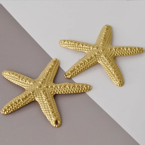 Detailed close-up of golden starfish charms with textured surface for DIY jewelry