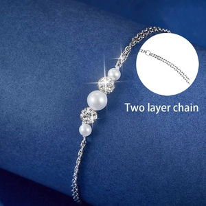 Detailed macro view of S925 silver double-layer chain with pearls and zircon beads
