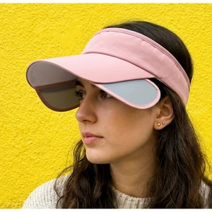 Close-up view of a pink outdoor sun visor with retractable side flaps worn by a model