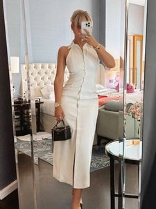 Detail of white halter neck maxi dress featuring a button-down front and collar design