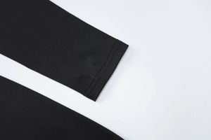 Detailed close-up showing the double-needle stitching on the black long sleeve cuff