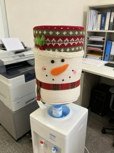 Detailed view of snowman Christmas water dispenser cover with knit hat and plaid scarf