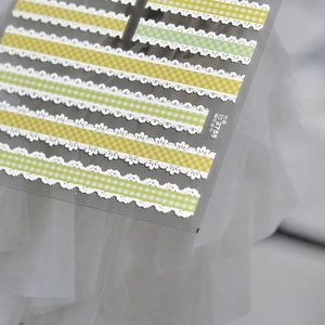 Detail of TO 2755 embossed lace checkered nail stickers in bright yellow and green