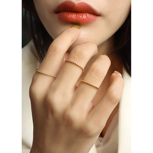 Three-piece set of minimalist 18k gold plated beaded rings for women on hand