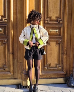 Outdoor street style shot of a quilted color-block jacket with vintage contrast trim details