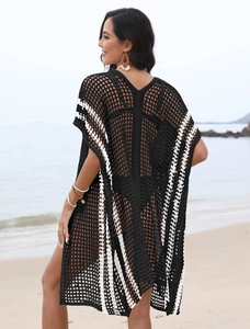 Detail of bohemian crochet beach cover-up featuring black and white hollow knit patterns