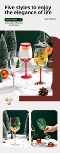 Macro detail of hand-painted Christmas tree and Santa patterns on festive wine glass