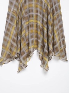 Close-up of lightweight plaid midi skirt hem showing yellow and grey checkered texture