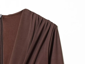 Detail of brown pleated shoulder seam and invisible zipper on elegant women's midi dress