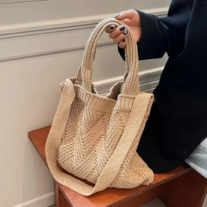 Close-up of beige knitted tote bag featuring detailed woven texture and sturdy straps