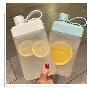 Detail of square plastic water bottles with carrying loops and lemon slices inside