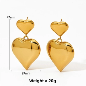 Detail view of gold-plated hollow heart earrings showing dimensions 47mm by 29mm