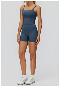 Detail view of high-waist yoga shorts and racerback sports bra in dusty blue matte fabric