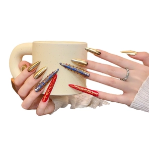 Luxurious court style stiletto press-on nails with gold mirror finish and pearl details