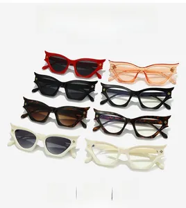 Detail view of colorful cat-eye sunglasses with golden geometric temple accents