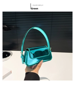 Detail view of mint green patent leather baguette bag with shiny reflective mirror finish