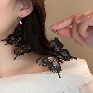 Retro butterfly drop earrings with dark translucent wings and delicate wing textures