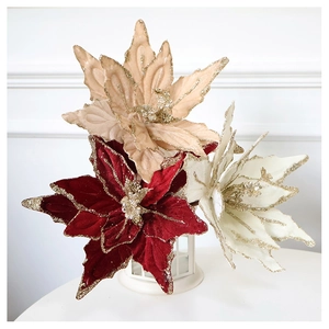 Close-up of velvet poinsettia flowers with gold glitter edges for Christmas decor
