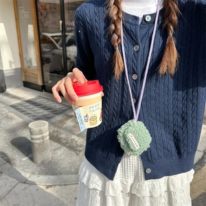 Mini plush earphone case in light green faux fur with purple neck strap and flap closure