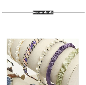 Detail view of various fabric and pearl headbands on a beige velvet display stand