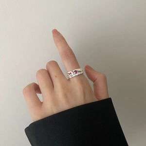 Irregular textured silver ring featuring pink stones in a lava-style artistic design