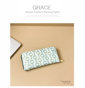 Detailed top view of long women's wallet with green chain pattern and gold zipper
