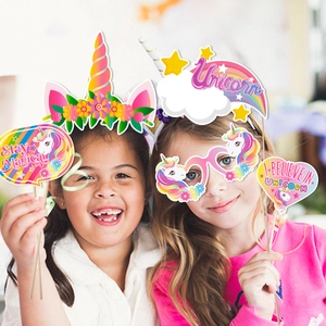 Unicorn party props with fun glasses and magical signs used by two young girls