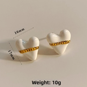 Macro shot of 16mm white enamel heart earrings with gold chain trim and size markings