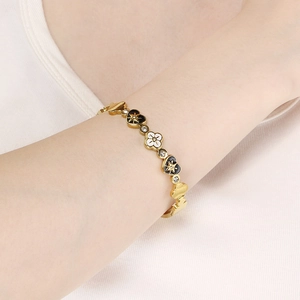 European gold-plated heart and star charm bracelet featuring enamel details and crystals