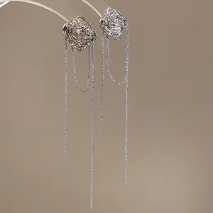 Irregular textured silver tassel drop earrings with long metallic fringe strands