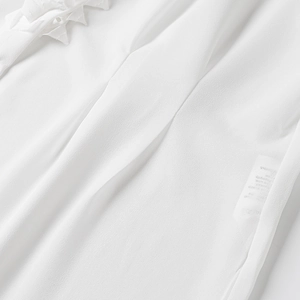 Close-up of lightweight white chiffon fabric with fine texture and lace details