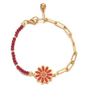 Detail of bohemian gold chain bracelet with red crystal beads and enamel daisy charm