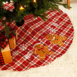 Red plaid Christmas tree skirt with gingerbread man and snowflake embroidery on fur rug